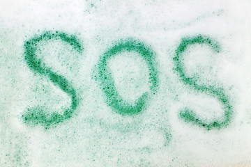 Inscription SOS on soap foam