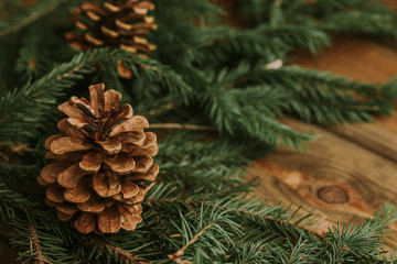 Christmas background. Green branch with needles on wooden table with empty copy space on the side.
