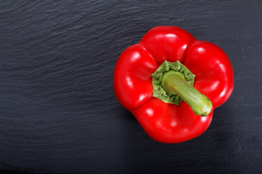 Red Bell Pepper On Black Slate Stone Plate With Copy Space