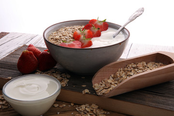 Bowl of homemade granola muesli with yogurt and fresh berries.