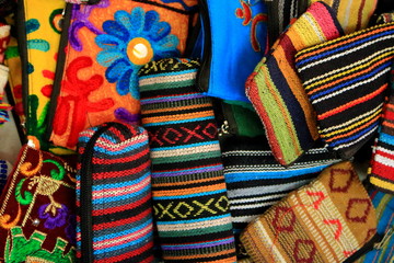 Amount of handmade indian traditional small purses as colorful bright background of indian culture.