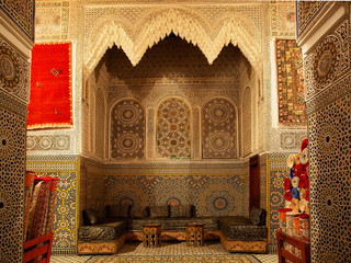 Typical Moroccan riad house with brown mosaic and carpets - Fes, Africa, Morocco