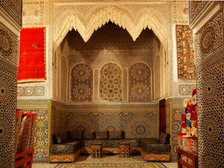 Poster Typical Moroccan riad house with brown mosaic and carpets - Fes, Africa, Morocco © Natalia Schuchardt