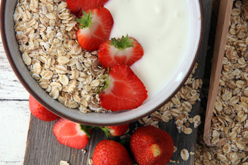Bowl of homemade granola muesli with yogurt and fresh berries.