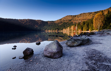 water reflection at volcano lake saint ana in romania