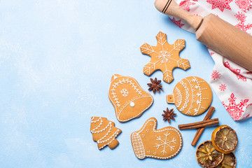 Christmas gingerbread cookies and spices on blue.