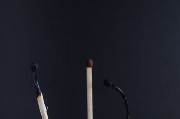 Three matches on a black background