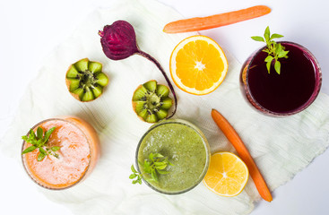 Various smoothies with ingredients on a table