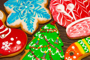 Christmas gingerbread colorful glaze coating,  close-up on wooden background