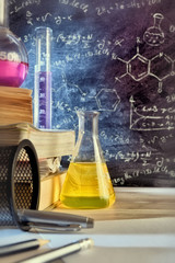 Classroom desk and drawn blackboard of chemistry teaching vertical