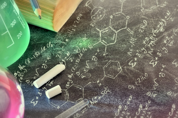 Classroom desk and drawn blackboard of chemistry teaching top
