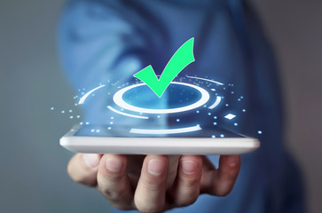 Man holding green check mark symbol.