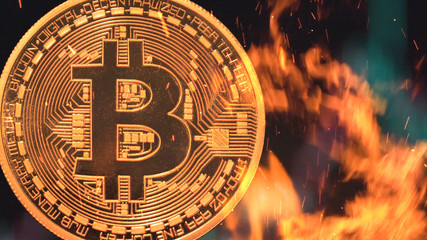 Bitcoin - bit coin BTC cryptocurrency money burning in flames and fire sparkles
