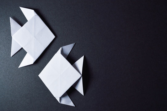origami fishes on dark background