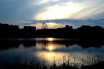 sunset in city water and devil mill