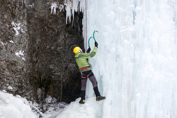 The climber climbs on ice.