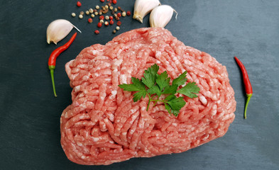 Fresh minced meat on dark stone background