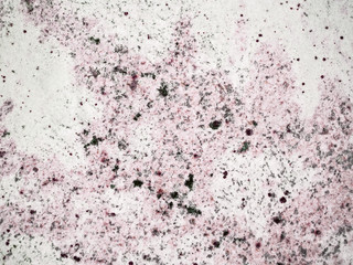 A close-up of a surface of treated rose granite stone plate. A fragment of a stone wall decoration. Texture of rose granite facing material.