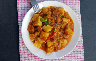Stewed potatoes on white plate