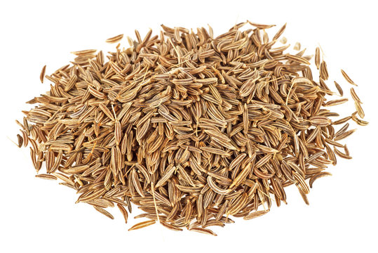 Dried cumin seeds on a white background