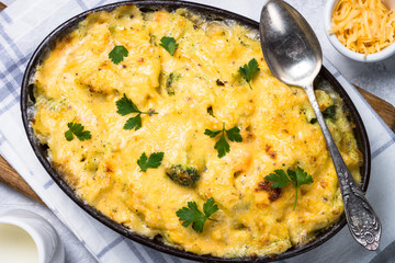 Gratin or Casserole in baking dish. Pasta fish cheese and vegetables. Top view.