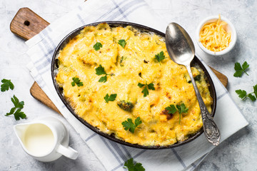 Gratin or Casserole in baking dish. Pasta fish cheese and vegetables. Top view.
