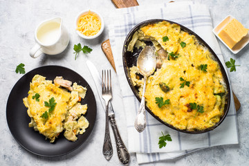 Gratin or Casserole in baking dish. Pasta fish cheese and vegetables. Top view.