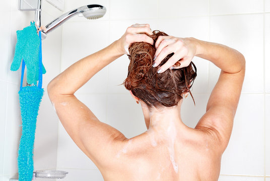 Closeup shot of woman washing her hair in a shower