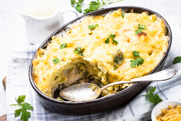 Gratin or Casserole in baking dish. Pasta fish cheese and vegetables. Top view.