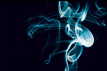 Swirls of blue smoke on a black background