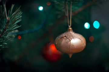 Christmas dark background with a Christmas tree toys and bokeh lights