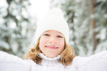Happy child in winter park
