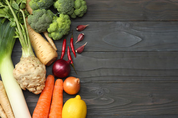 Fresh vegetables on dark wooden background. Mockup for menu or recipe. Top view with copy space