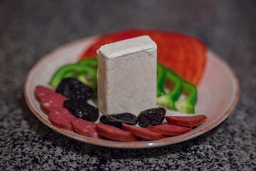 Dish with fresh vegetables. Tomato, pepper, sausage, cheese. Ideal for appetizer.