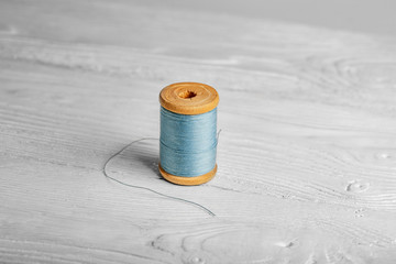 thread for a sewing machine on a wooden background