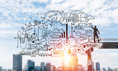 Businessman drawing business conceptual sketches.