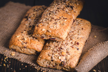 Healthy rye-wheat sourdough bread. Homemade whole grain fitness bread sprinkled with seeds. Front view.