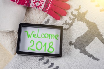 Welcome 2018. Christmas clothing style background - knitted sweater, scarf, hat, mittens.