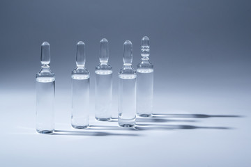 Medical ampules for injection isolated on blue background