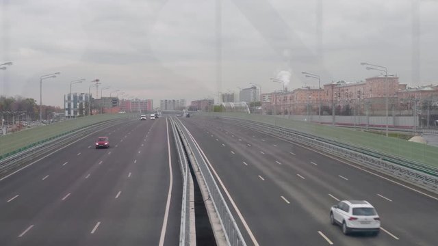 View from bridge of large city road with cars moving on it