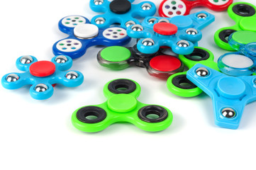 Various colored fidget spinners - stress relieving toys on a white background