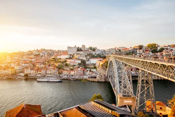 Foto op Canvas Panoramic landscape view on the old town with Douro river and famous iron bridge in Porto city during the sunset in Portugal © rh2010