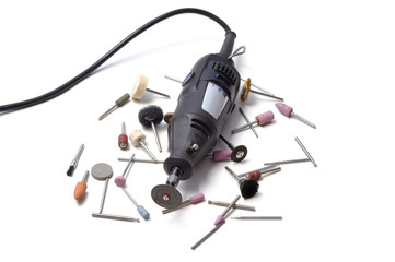 Mini drill with various nozzles and cutters on a white background