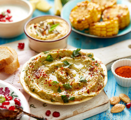 Avocado hummus sprinkled wth paprika powder an fresh parsley, delicious and healthy vegetarian spread