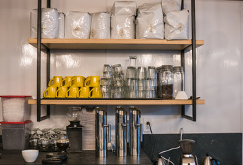 Shelf with coffee mugs and glasses