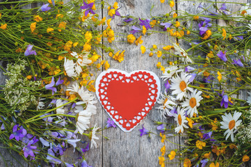 Beautiful background of flowers field of daisies and bells and hearts for Valentine's Day. Copy space.