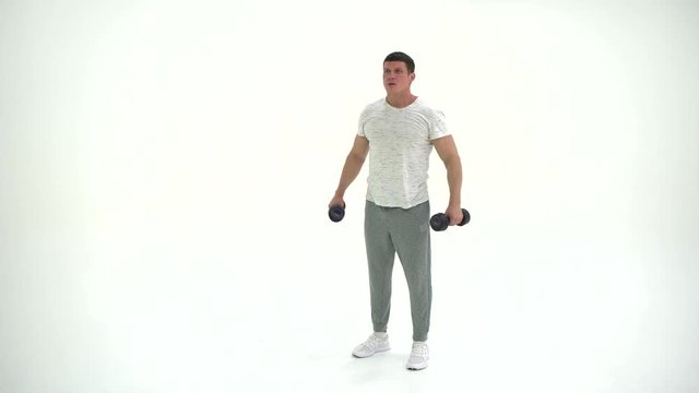 Fitness athlete man Working Out With Dumbbells in studio on a white background 4K