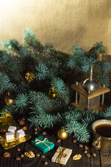 Coffee grinder, coffee beans and Christmas tree branch on a wooden table