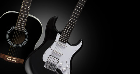 Fototapeta na wymiar Black acoustic and electric guitars on a black background.