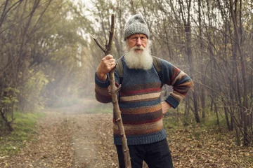 Tuinposter old man with beard in forest © sutulastock
